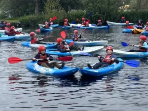 A large group of students kayaking.