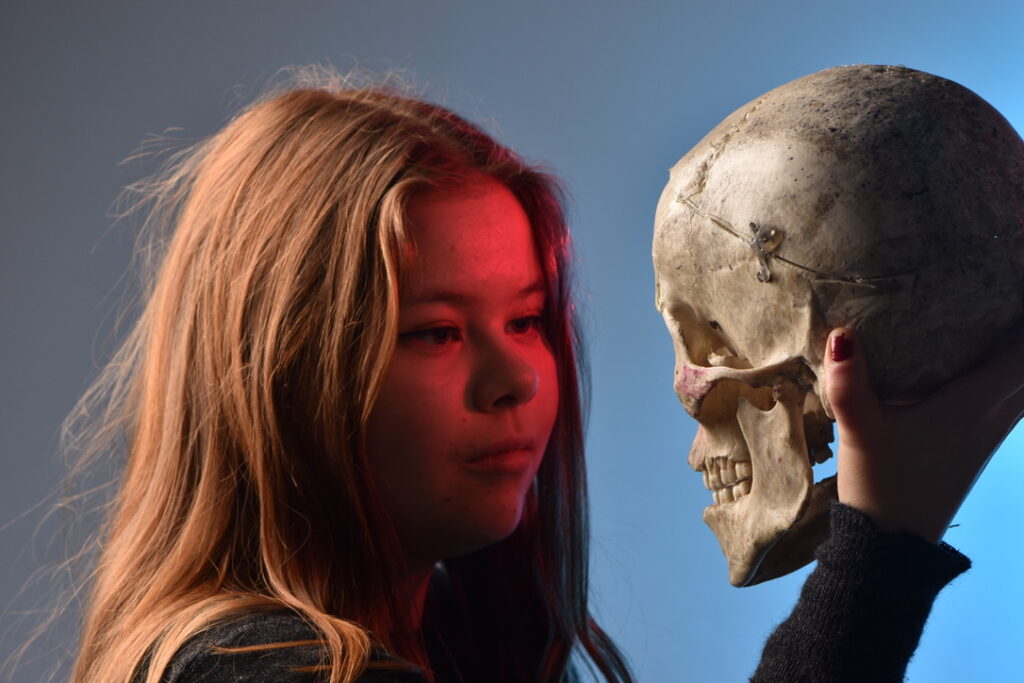A student holding a skull.